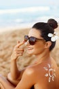 Suntan Lotion. Sexy Young Woman in Bikini  Applying Sunscreen Solar Cream.Sun Protection. Sun Cream Royalty Free Stock Photo