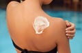 Suntan Lotion. Sexy Young Woman in Bikini  Applying Sunscreen Solar Cream.Sun Protection. Sun Cream. Skin and Body Care. Royalty Free Stock Photo