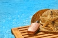 Suntan lotion and straw hat Royalty Free Stock Photo