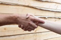 Suntanned male and female hands make handshake Royalty Free Stock Photo