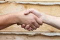 Suntanned male hands make handshake Royalty Free Stock Photo