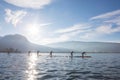 SUP board race in France Alps lake Annecy. Sunny winter day. Professional sport event