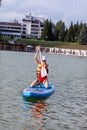 SUP board up paddle girl boarding on lake standing happy on water Royalty Free Stock Photo
