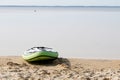 Sup paddle board lying on sand near beach lake water on the lakeside