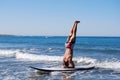 Man in headstand on SUP Royalty Free Stock Photo