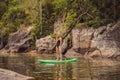 SUP Stand up paddle board woman paddle boarding on lake standing happy on paddleboard on blue water. Action Shot of Royalty Free Stock Photo