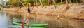 SUP Stand up paddle board woman paddle boarding on lake standing happy on paddleboard on blue water. Action Shot of Royalty Free Stock Photo