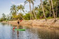 SUP Stand up paddle board woman paddle boarding on lake standing happy on paddleboard on blue water. Action Shot of Royalty Free Stock Photo