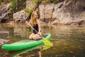 SUP Stand up paddle board woman paddle boarding on lake standing happy on paddleboard on blue water. Action Shot of Royalty Free Stock Photo