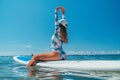 SUP Stand up paddle board. Young woman sailing on beautiful calm sea with crystal clear water. The concept of an summer holidays Royalty Free Stock Photo