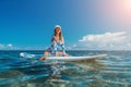 SUP Stand up paddle board. Young woman sailing on beautiful calm sea with crystal clear water. The concept of an summer holidays Royalty Free Stock Photo