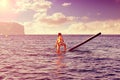 SUP Stand up Surf girl with paddle Royalty Free Stock Photo