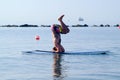 Headstand on stand up paddle board Royalty Free Stock Photo