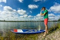 Sup surfing man stand up paddle boarder paddling at sunset on river Royalty Free Stock Photo