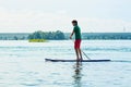 Sup surfing man stand up paddle boarder paddling at sunset on river Royalty Free Stock Photo