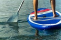 Sup surfing man stand up paddle boarder paddling at sunset on river Royalty Free Stock Photo