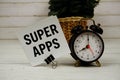 Super Apps text message on sticky note with alarm clcok on wooden background Royalty Free Stock Photo