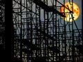 super blood moon over dark sky and silhouette structure