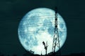 Super Blue Worm Moon and silhouette power electric pole and night sky