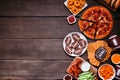 Super Bowl or football theme food side border on a dark wood background Royalty Free Stock Photo