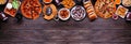 Super Bowl or football theme food top border on a dark wood banner background Royalty Free Stock Photo