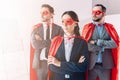 super businesspeople in masks and capes looking away with crossed arms Royalty Free Stock Photo