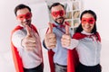 super businesspeople in masks and capes showing thumbs up Royalty Free Stock Photo
