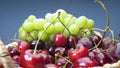 Super close up. Details of cherries, green and red grapes in a basket