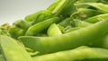 Super closeup. details of green pea pods in a basket on a table