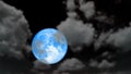 Super cold blue moon rise back blur dark cloud on the night sky