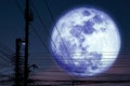 Super dark blue moon back silhouette power electric line on night sky