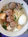 Super delicious gravy meatballs in a bowl with additional toppings of boiled eggs, fried tofu and vegetables