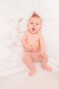 Super excited baby girl lying next to her bunny toy Royalty Free Stock Photo