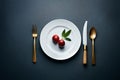 Super expensive restaurant table setting, plate and cutlery isolated on pastel black background