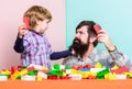 Super father. building home with colorful constructor. happy family leisure. child development. small boy with dad