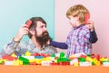 Super father. building home with colorful constructor. happy family leisure. child development. small boy with dad