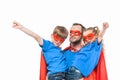 super father with children in masks and cloaks pretending to be superheroes