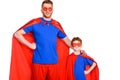 super father and son in masks and cloaks standing together and smiling at camera