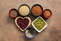 Super food cereals, legumes, seeds on a brown background. Chia, quinoa, beans, buckwheat, lentils, sesame, pumpkin seeds. Top view