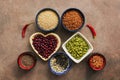 Super food cereals, legumes, seeds and chili peppers on a brown background. Chia, quinoa, beans, buckwheat, lentils, sesame,