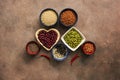 Super food cereals, legumes, seeds and chili peppers on a brown background. Chia, quinoa, beans, buckwheat, lentils, sesame,