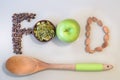 Super Food concept, pine nuts, cedar cones, wooden spoon and green apple on a light background.