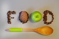 Super Food concept, pine nuts, cedar cones, wooden spoon and green apple on a light background. Royalty Free Stock Photo