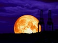 super full blood moon back mountain and silhouette crain at seaport Royalty Free Stock Photo