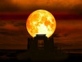 super full blood moon over abandon silhouette temple in the sea Royalty Free Stock Photo