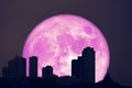 super full harvest moon on night sky and silhouette city and building Royalty Free Stock Photo
