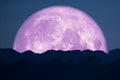 super full pink moon back on silhouette mountain on night sky Royalty Free Stock Photo