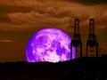 super full purple moon back mountain and silhouette crain at sea Royalty Free Stock Photo