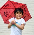 A super happy child carrying umbrella; casual portrait