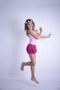 Super Happy jumping girl with bare feet and roses on head